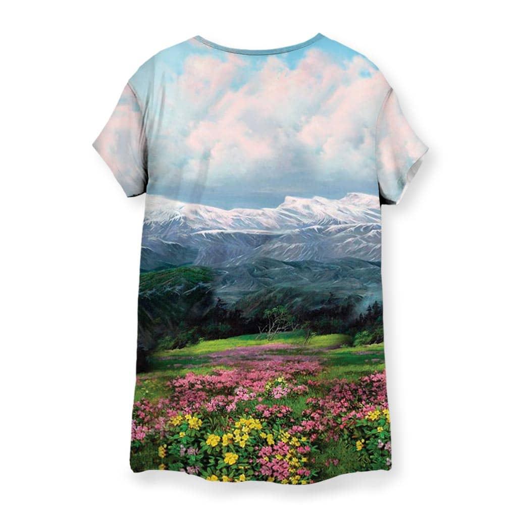 Glorious Dear Leader Women's Tee - The signature utilitarian khaki suit (#B08D65) juxtaposed against the hyper-idealized, soft-focus alpine backdrop with lush meadow greens (#2E8B57), blooming magenta wildflowers (#C71585), snow-capped slate grey mountains, and cerulean blue sky (#87CEEB) typically reserved for romantic landscape paintings