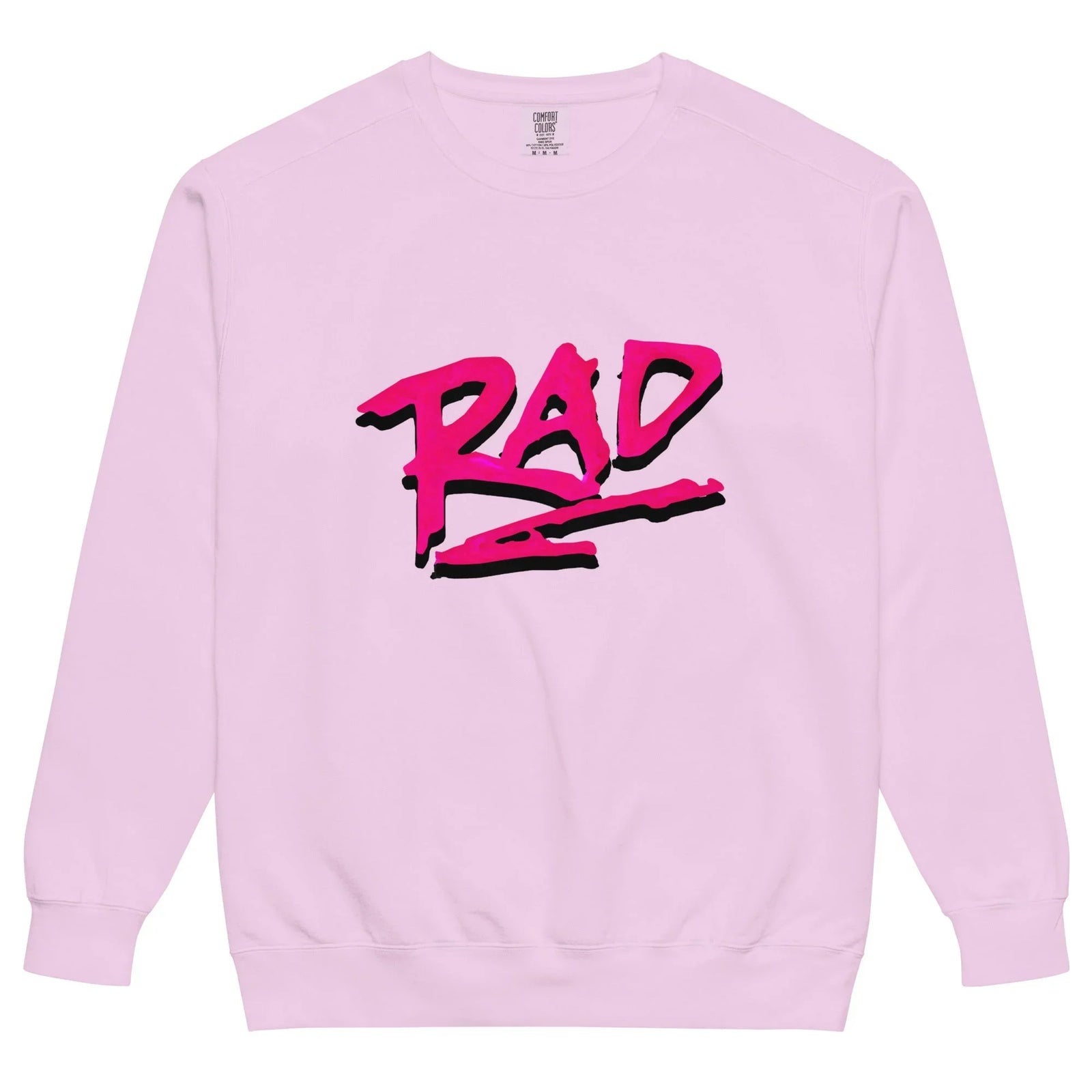 A soft pastel pink crewneck showcases "RAD" in jagged, graffiti-style lettering across the chest—vibrant magenta with a bold black drop shadow that creates a striking 3D pop. Contact us with accessibility feedback, we'd love to help!