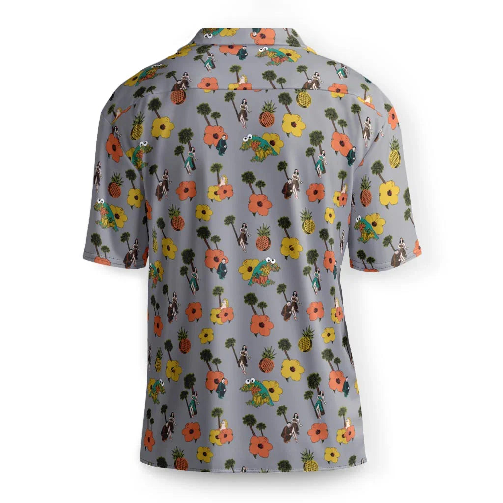 Maui Kim Hawaiian Shirt - The stoic, black-suited political figure placed directly beside the vibrant coral orange (#FF7F50) hibiscus and the azure-blue (#007FFF) puppet retching flowers.