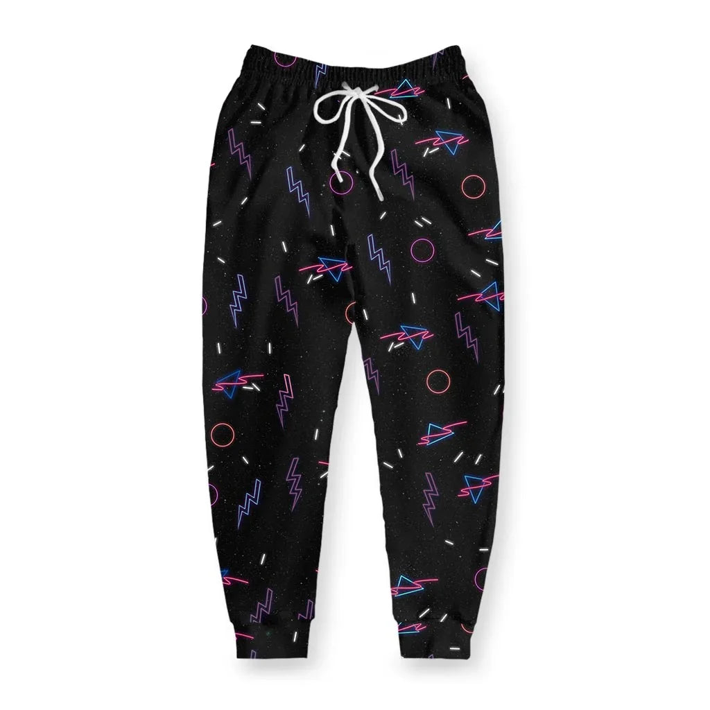 Black joggers explode with a chaotic 90s roller rink pattern—electric violet lightning bolts, hot magenta rings, and cyan triangular prisms float across the fabric like vintage arcade carpet come to life. Contact us with accessibility feedback, we'd love to help!