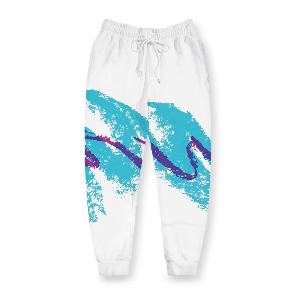 White joggers featuring a bold 90s-inspired graphic across the thigh—a jagged teal brushstroke (like vintage paper cup designs) overlaid with freehand purple scribbles. Contact us with accessibility feedback, we'd love to help!