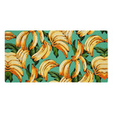 Set against a solid tropical seafoam green backdrop, dynamic clusters of ripe banana yellow fruit take center stage with sun-kissed orange highlights and bold black outlines. Contact us with accessibility feedback, we'd love to help!