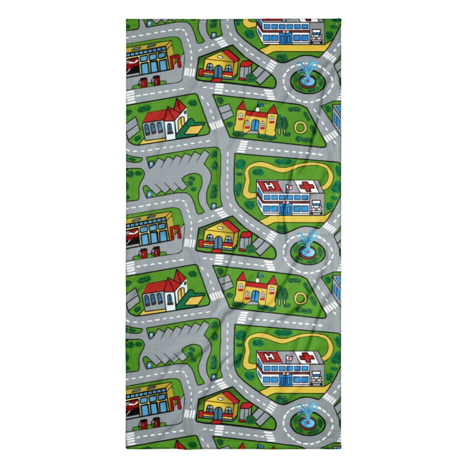 This beach towel showcases a nostalgic bird's-eye view of a miniature town playmat, complete with winding grey roads marked by white dashed lines curving around vibrant green parks. Contact us with accessibility feedback, we'd love to help!