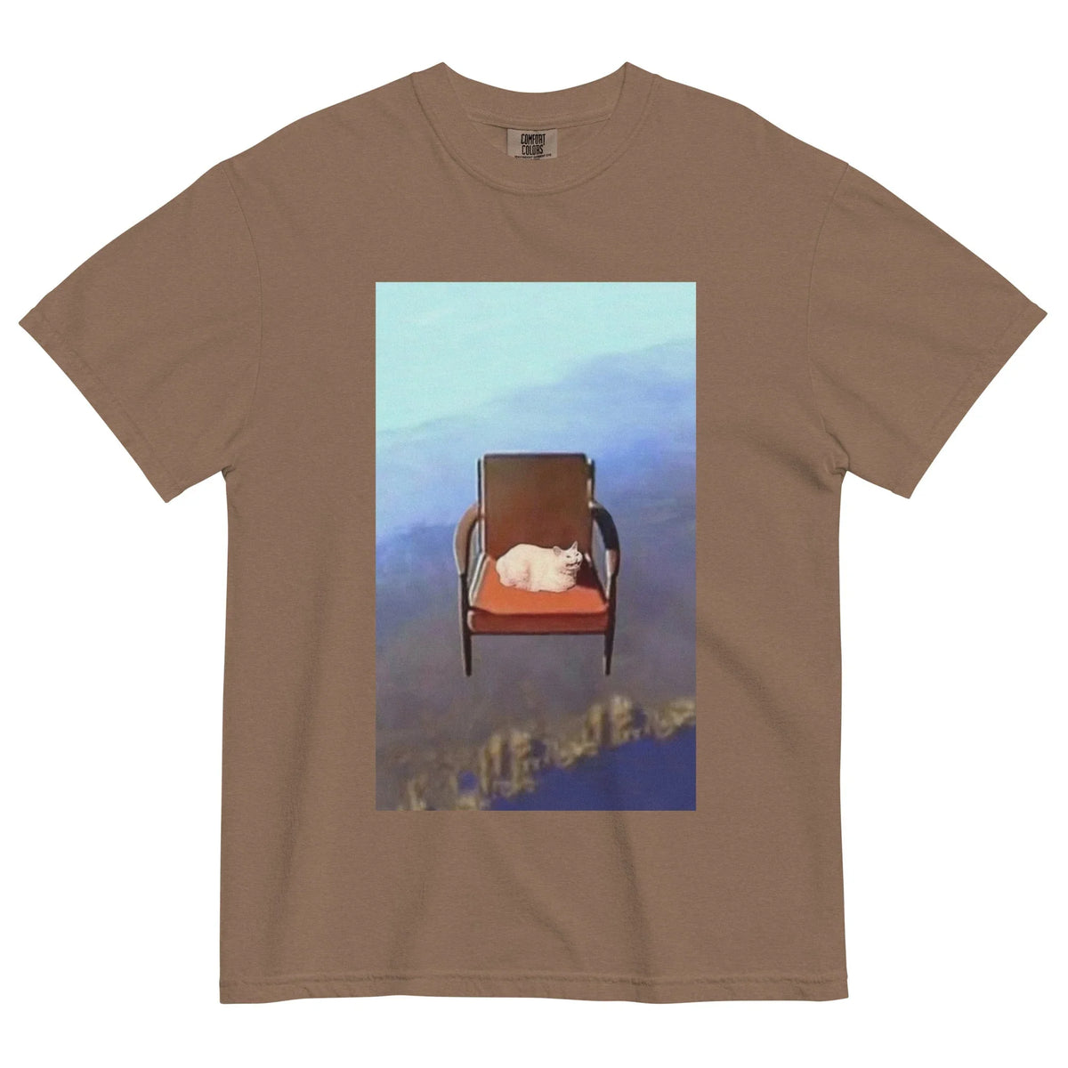 Doing Fine T-Shirt - The gravity-defying domestic scene featuring a white cat on a burnt sienna (#BE5640) armchair suspended in a glacial blue (#ADD8E6) to indigo (#48546A) void.
