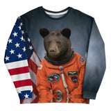 A photorealistic black bear in a vivid orange astronaut suit stands against a moody slate blue backdrop, complete with mission patches and metallic hardware. Contact us with accessibility feedback, we'd love to help!